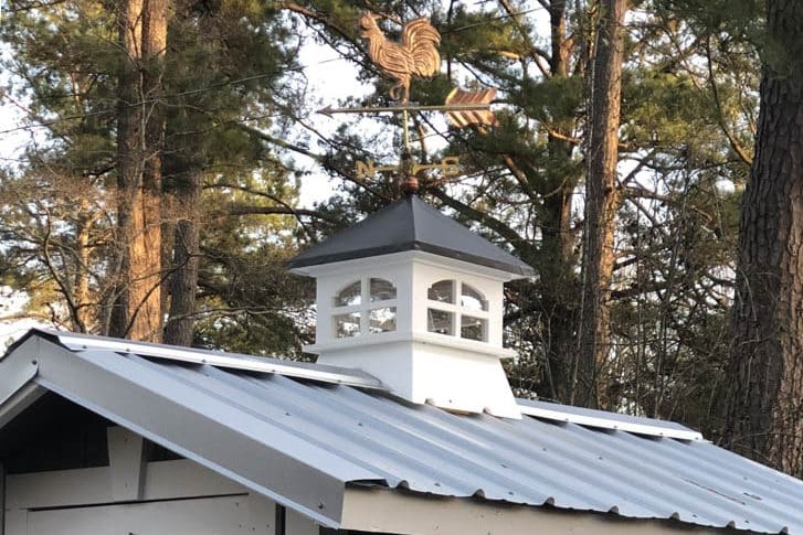 Small gray shed with white cupola